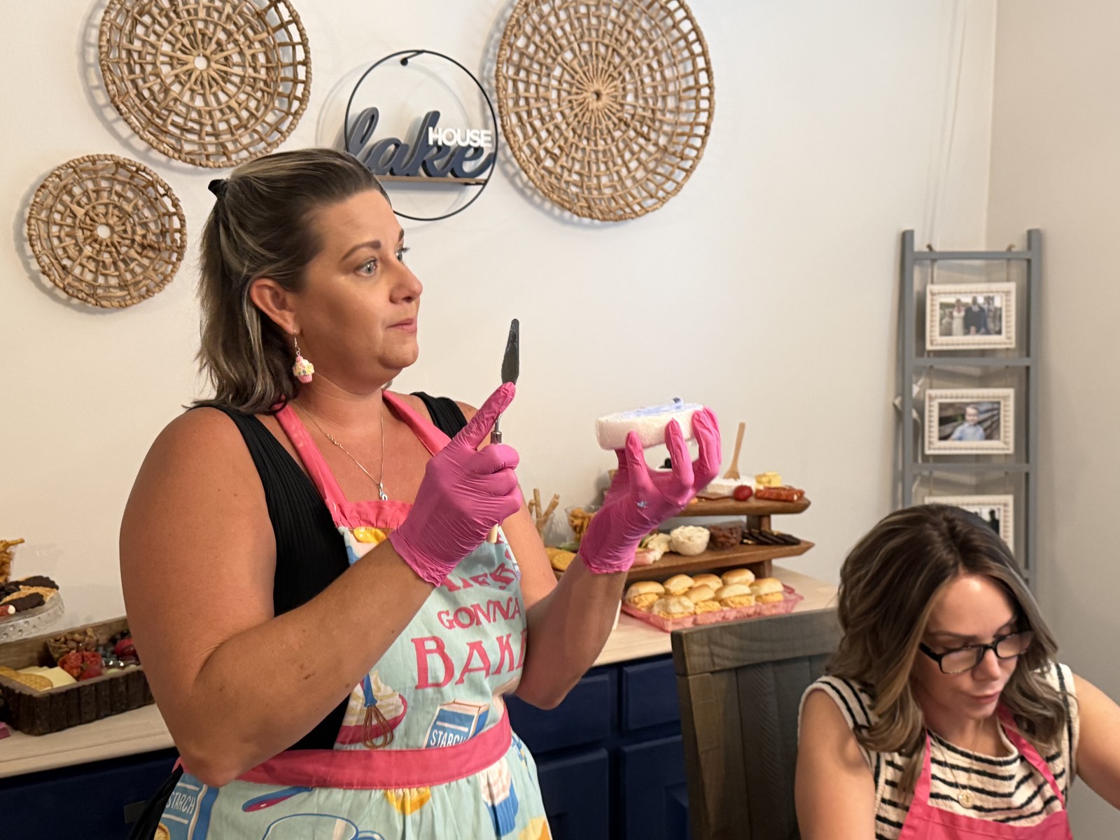 Hands-on frosting workshop with pink gloves